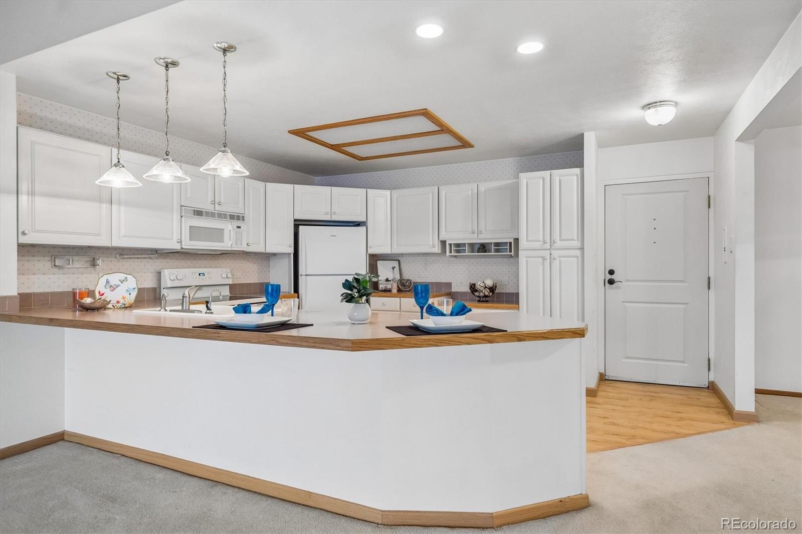 a kitchen with stainless steel appliances granite countertop a sink a stove and a refrigerator