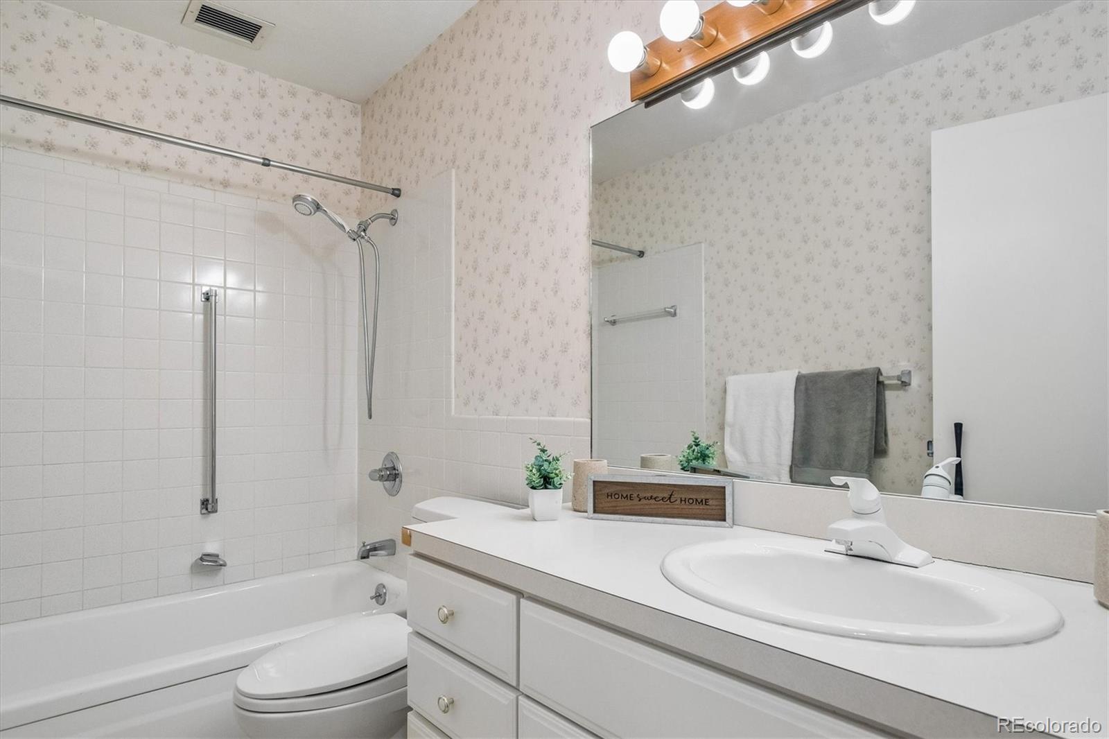 650 South Clinton Street, Unit 5D Denver, CO 80247 - Photo 17 of 48 a bathroom with a sink a toilet and shower