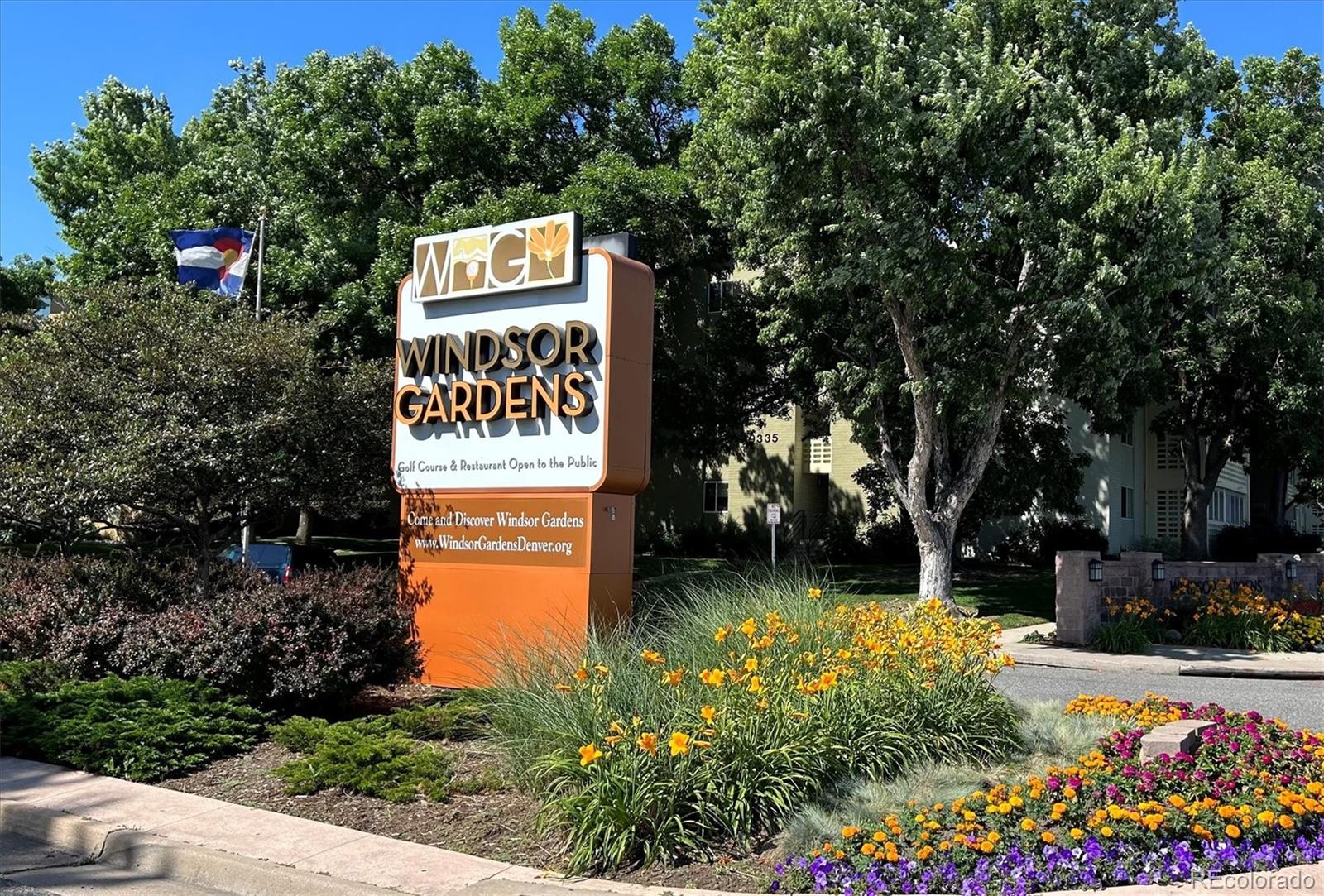 650 South Clinton Street, Unit 5D Denver, CO 80247 - Photo 24 of 48 a sign that is sitting in front of flowers