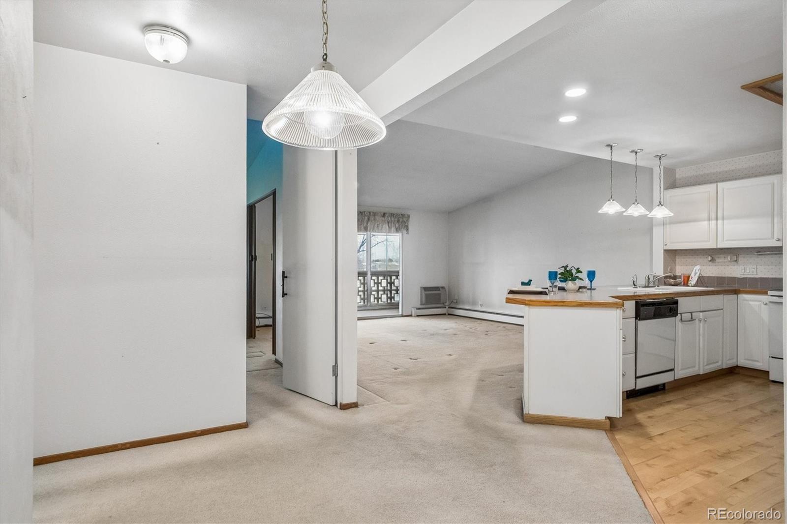 650 South Clinton Street, Unit 5D Denver, CO 80247 - Photo 6 of 48 a view of a kitchen with a sink stainless steel appliances and cabinets