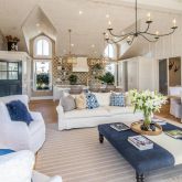 a living room with furniture a chandelier and a wooden floor