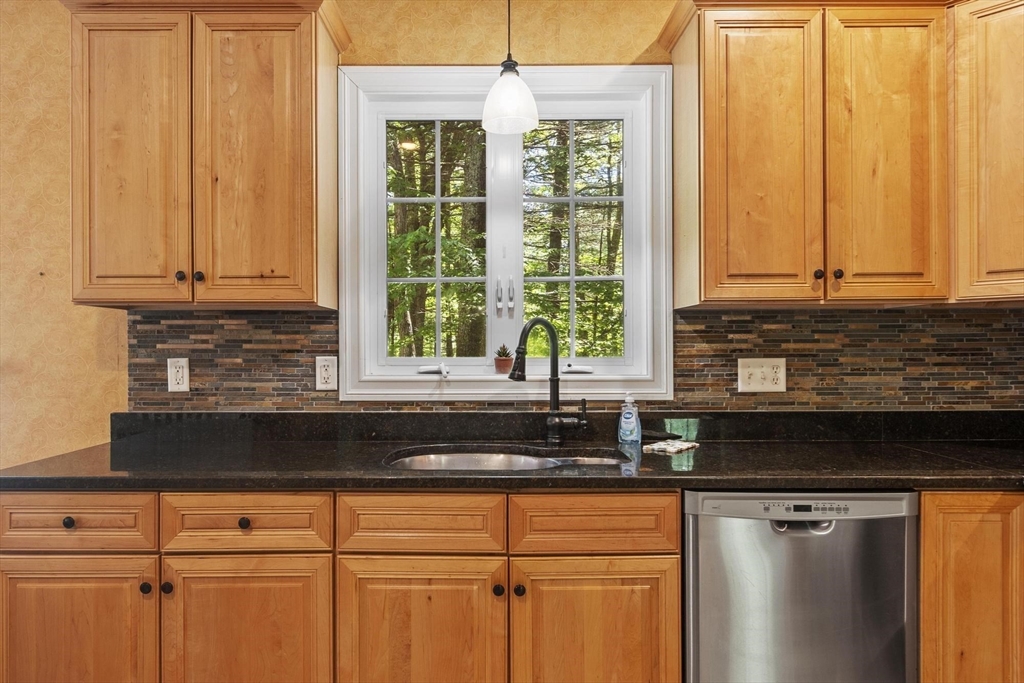 4 Forest Street Georgetown, MA 01833 - Photo 12 of 37 a kitchen with stainless steel appliances granite countertop a sink a window and cabinets