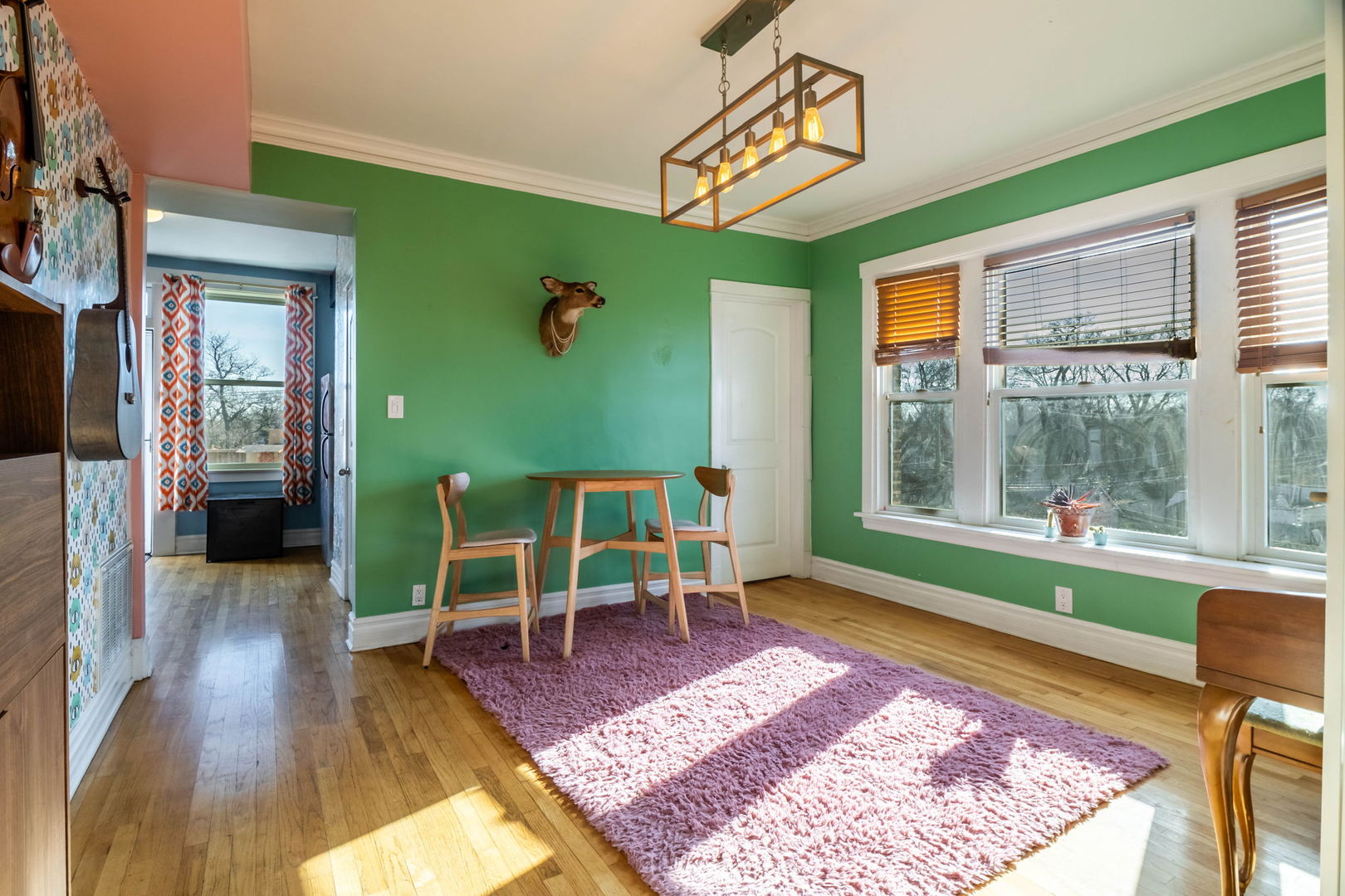 3737 North Pulaski Road, Unit 3S Chicago, IL 60641 - Photo 13 of 25 a living room with a rug wooden floor and a table