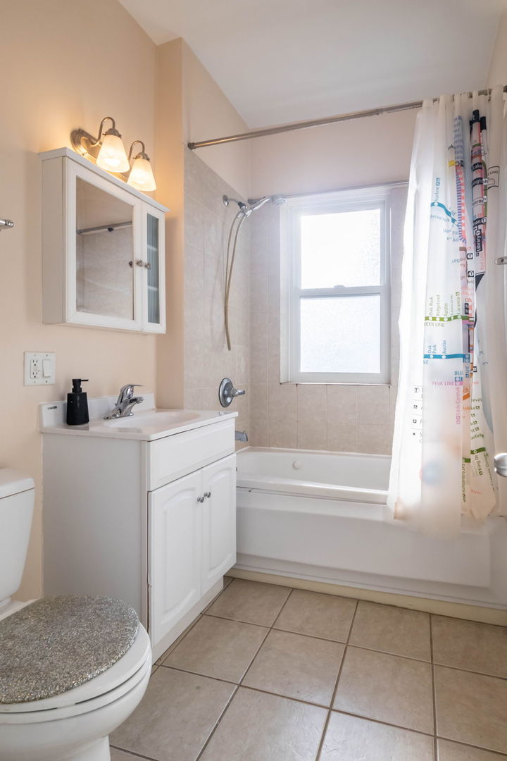 3737 North Pulaski Road, Unit 3S Chicago, IL 60641 - Photo 22 of 25 a bathroom with a granite countertop sink a toilet and a bathtub