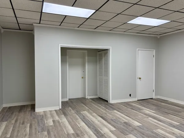 a view of a room with wooden floor