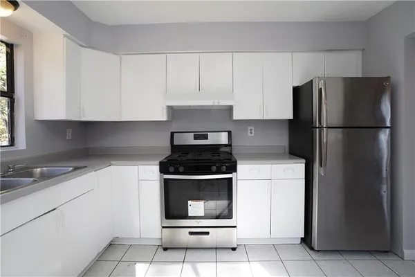 a kitchen with a stove cabinets and refrigerator