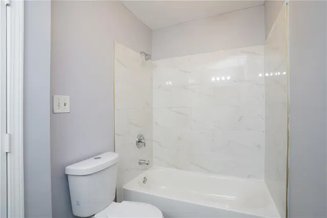 a bathroom with a bathtub and a toilet