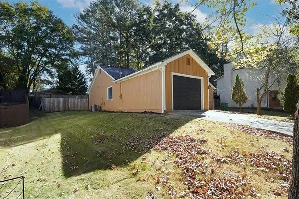 a wooden house with a large tree in front of it