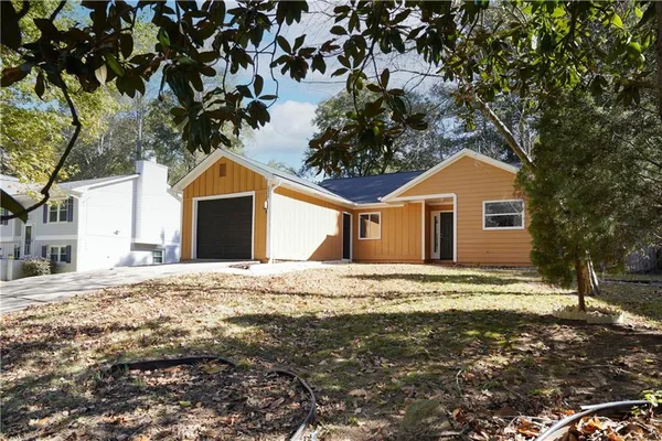 a house with a trees in front of it