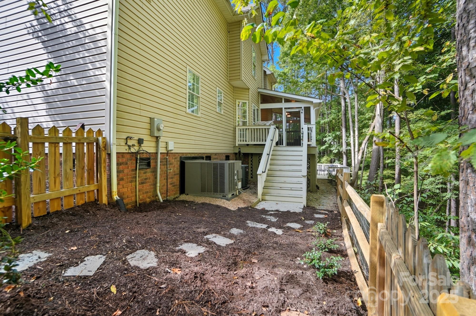 11177 Watertrace Drive Tega Cay, SC 29708 - Photo 24 of 28 a view of a house with backyard and trees