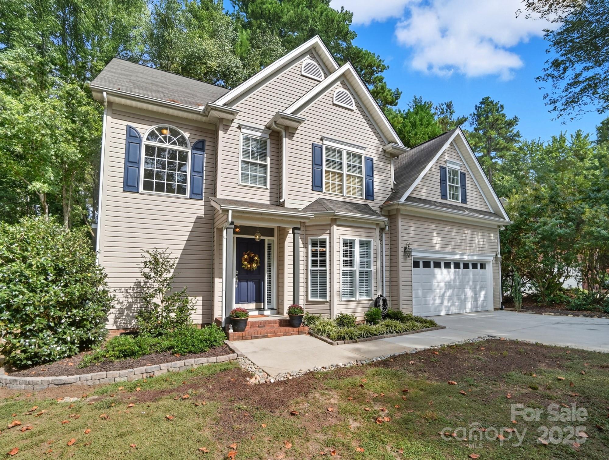 11177 Watertrace Drive Tega Cay, SC 29708 - Photo 3 of 28 a front view of a house with a garden