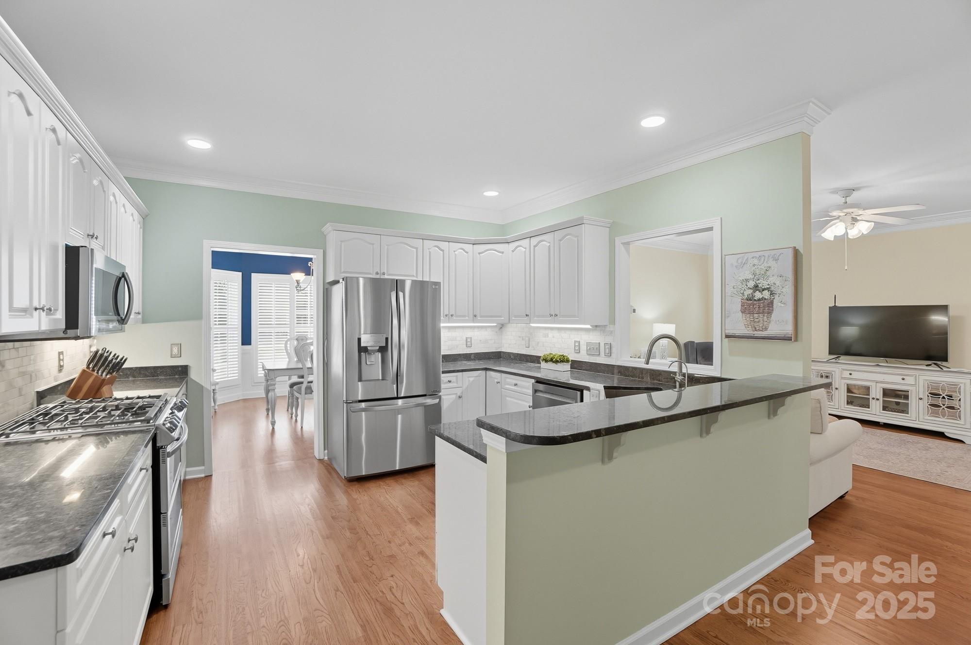 11177 Watertrace Drive Tega Cay, SC 29708 - Photo 9 of 28 a kitchen with stainless steel appliances granite countertop a refrigerator stove and sink