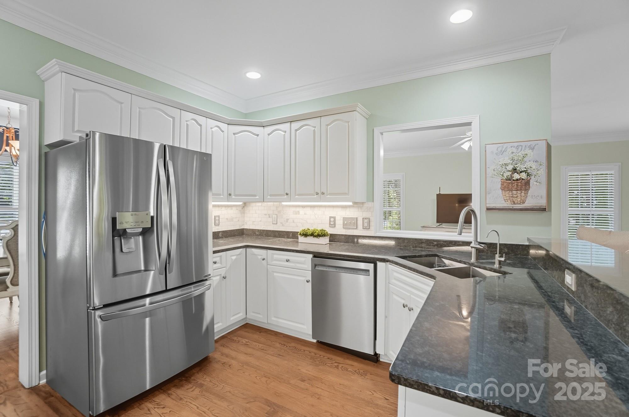 11177 Watertrace Drive Tega Cay, SC 29708 - Photo 10 of 28 a kitchen with stainless steel appliances granite countertop a refrigerator a sink and white cabinets