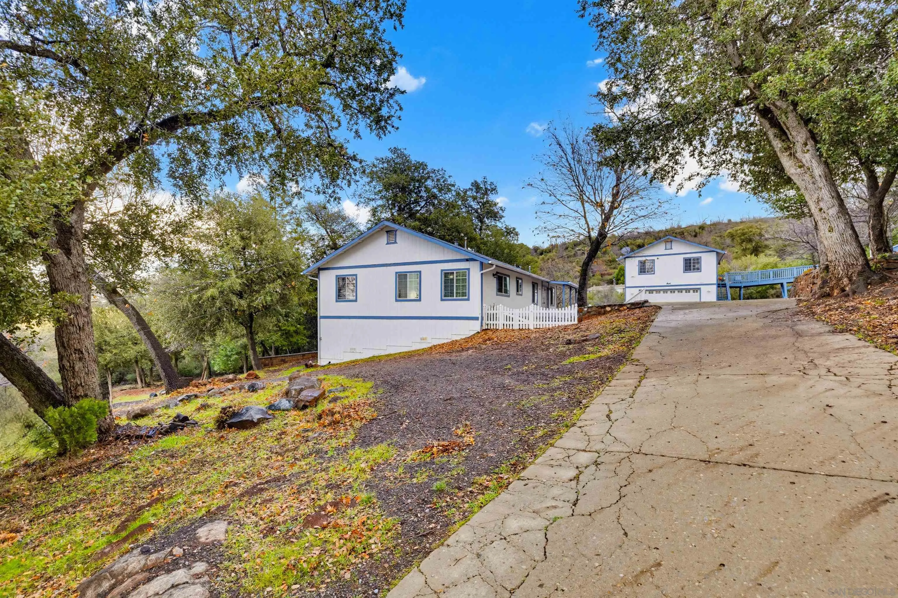 17009 Iron Springs Road Julian, CA 92036 - Photo 12 of 70 a backyard of a house with large trees and wooden fence