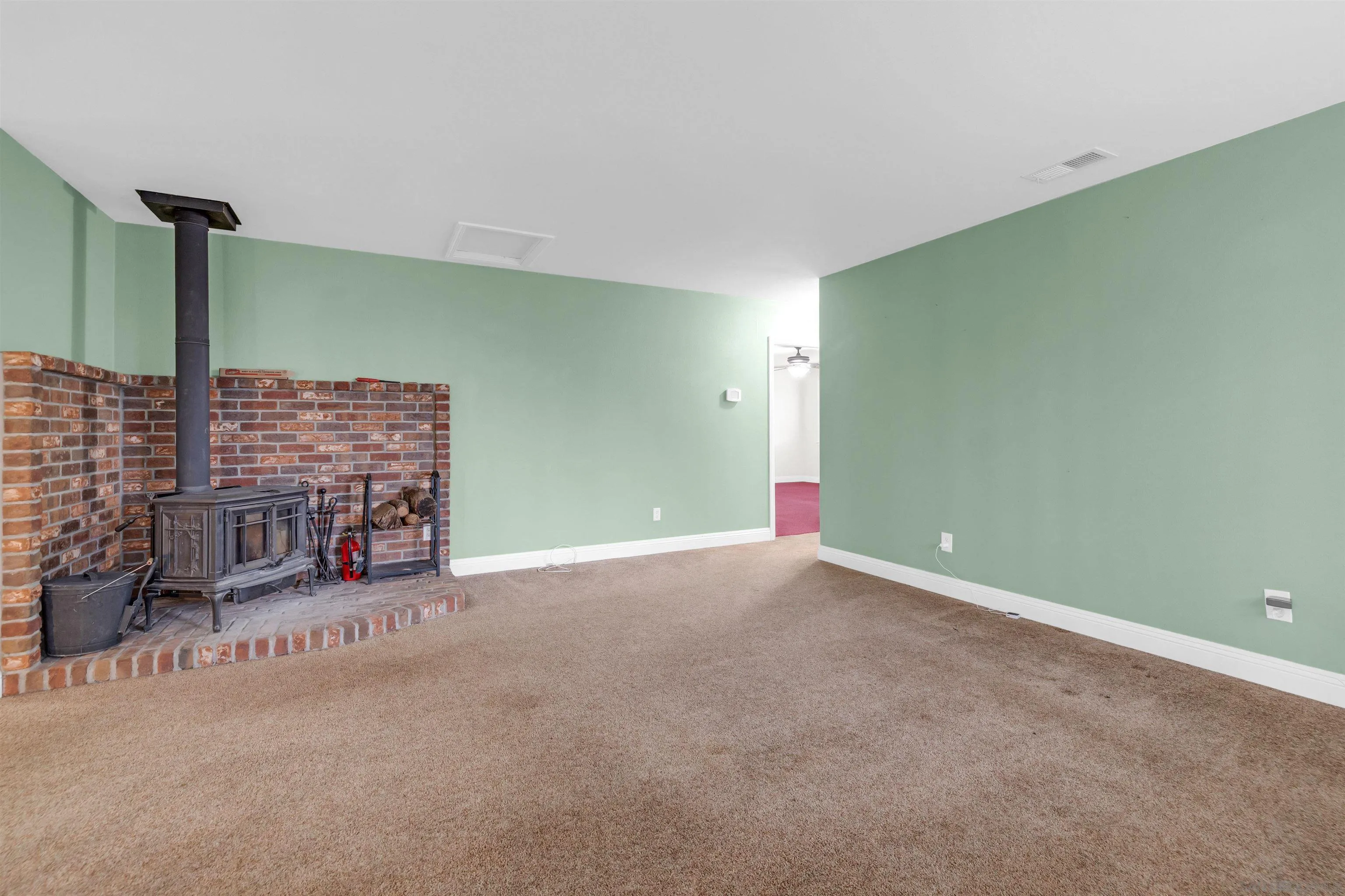 17009 Iron Springs Road Julian, CA 92036 - Photo 22 of 70 a view of an empty room with a fireplace