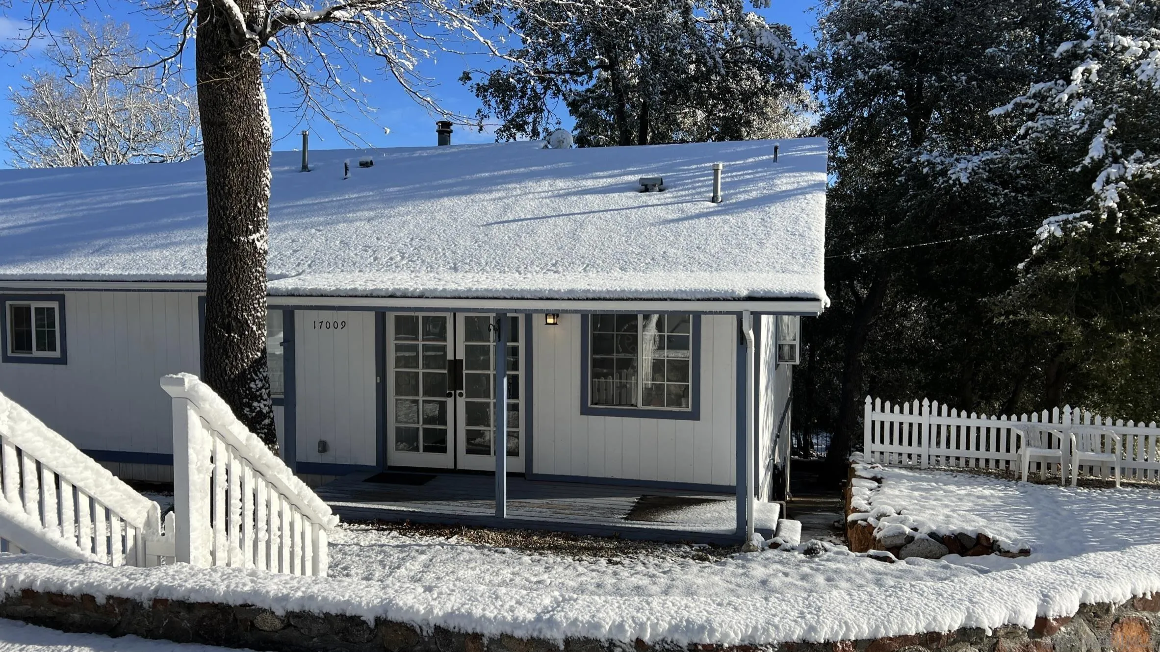 17009 Iron Springs Road Julian, CA 92036 - Photo 58 of 70 a view of a house with a small yard and wooden fence and floor to ceiling window