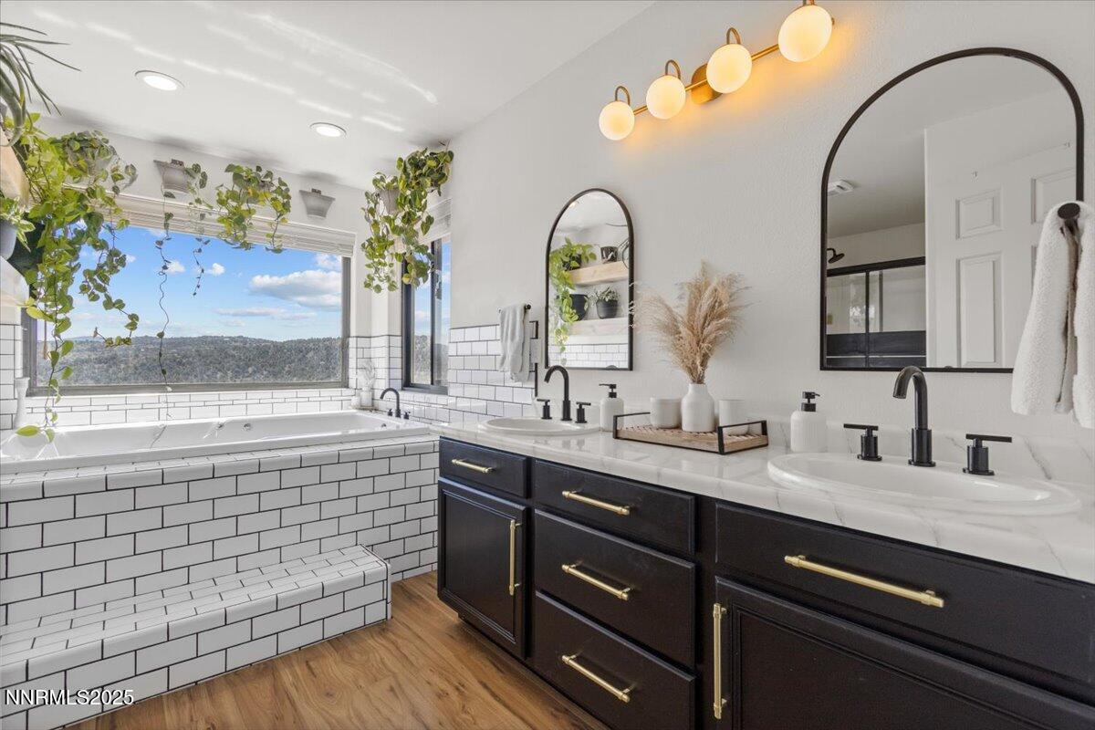 2371 Enterprise Road Reno, NV 89521 - Photo 1 of 25 a spacious bathroom with a double vanity sink a mirror and a bathtub