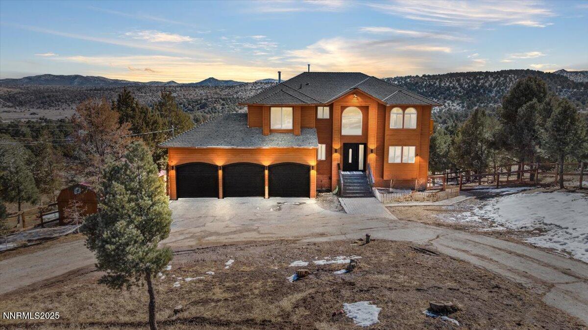 2371 Enterprise Road Reno, NV 89521 - Photo 3 of 25 a front view of a house with a yard and mountain view in back