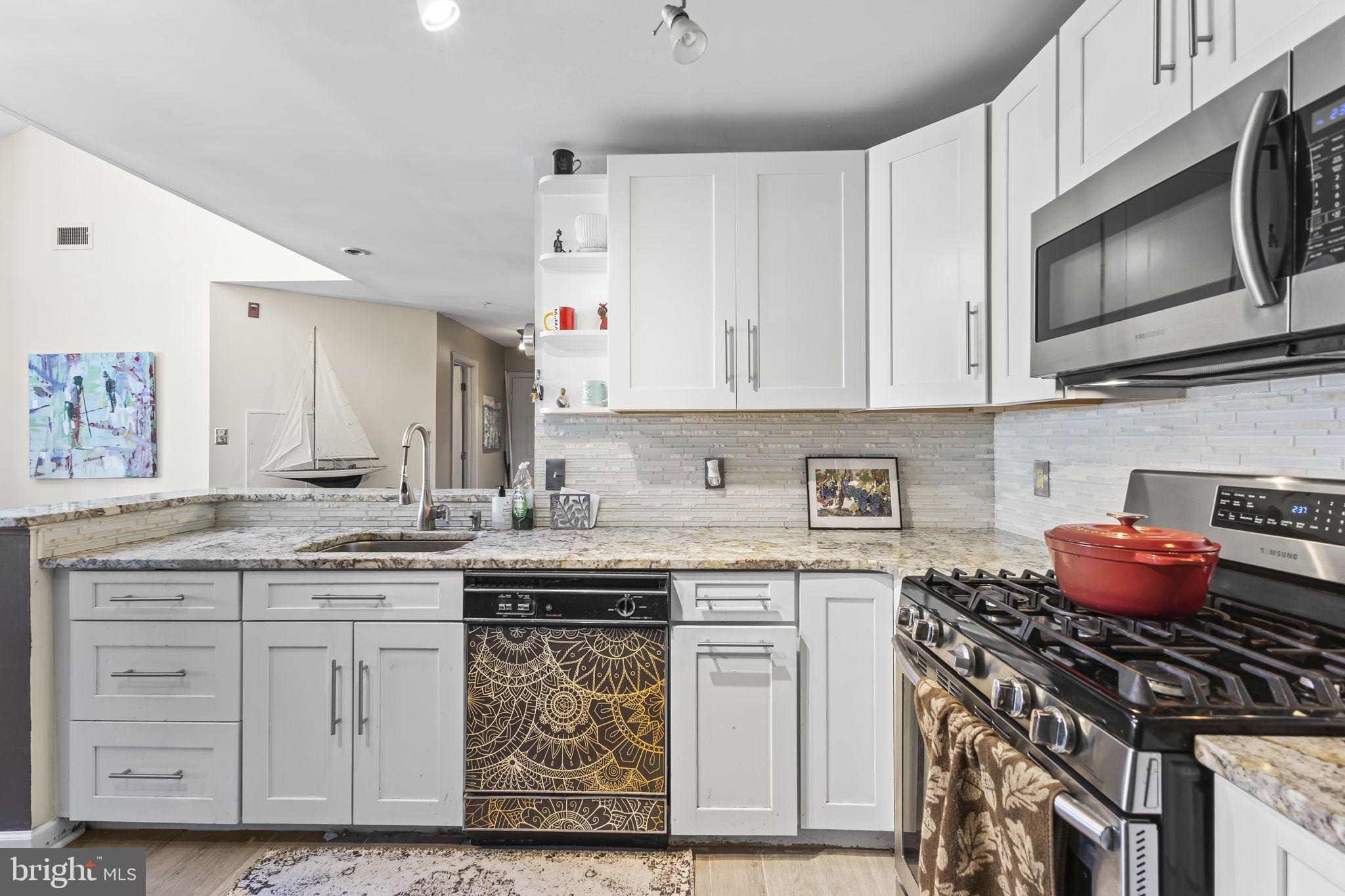 2320 Falls Gable Lane, Unit B Baltimore, MD 21209 - Photo 11 of 26 a kitchen with stainless steel appliances granite countertop a granite counter tops and a stove