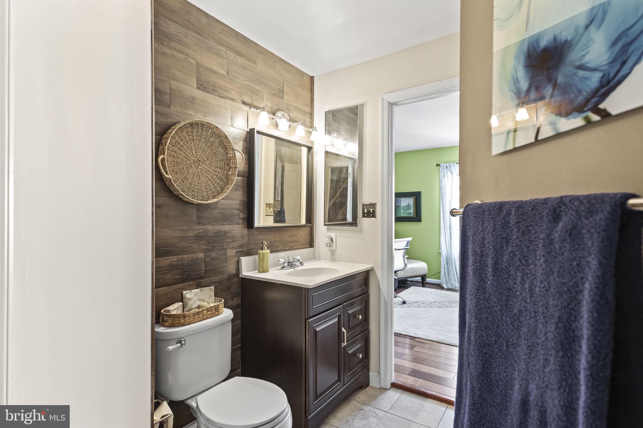 2320 Falls Gable Lane, Unit B Baltimore, MD 21209 - Photo 12 of 26 a bathroom with a toilet sink vanity granite and a mirror