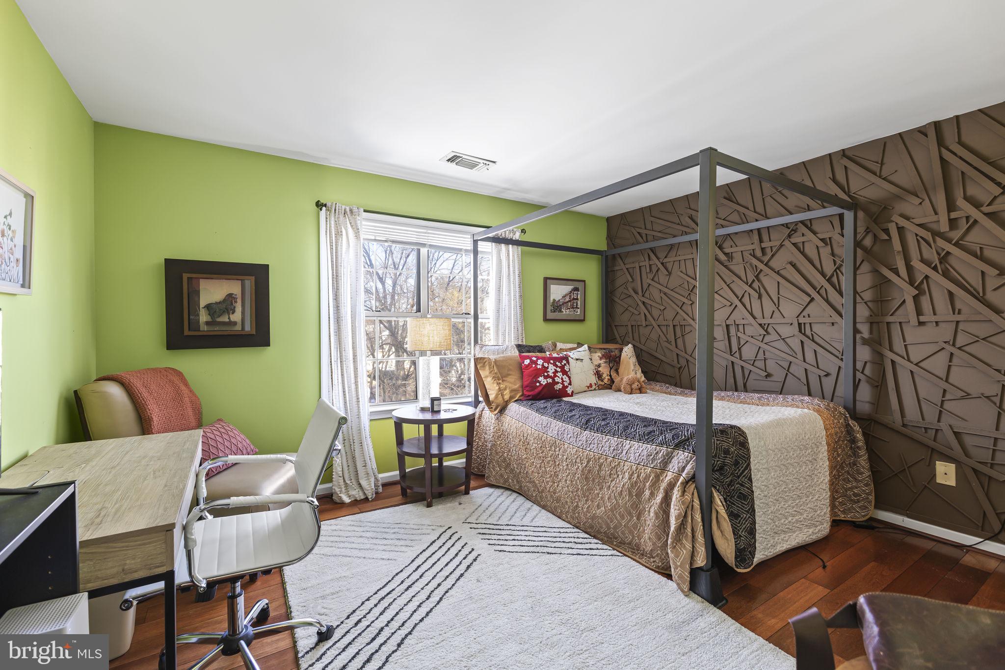 2320 Falls Gable Lane, Unit B Baltimore, MD 21209 - Photo 14 of 26 a bedroom with a bed and wooden floor