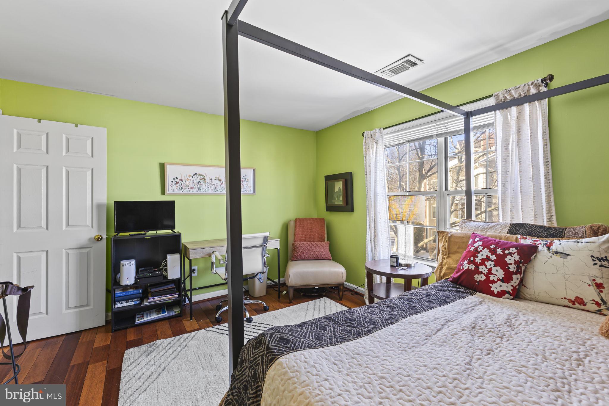 2320 Falls Gable Lane, Unit B Baltimore, MD 21209 - Photo 16 of 26 a bedroom with a bed and wooden floor