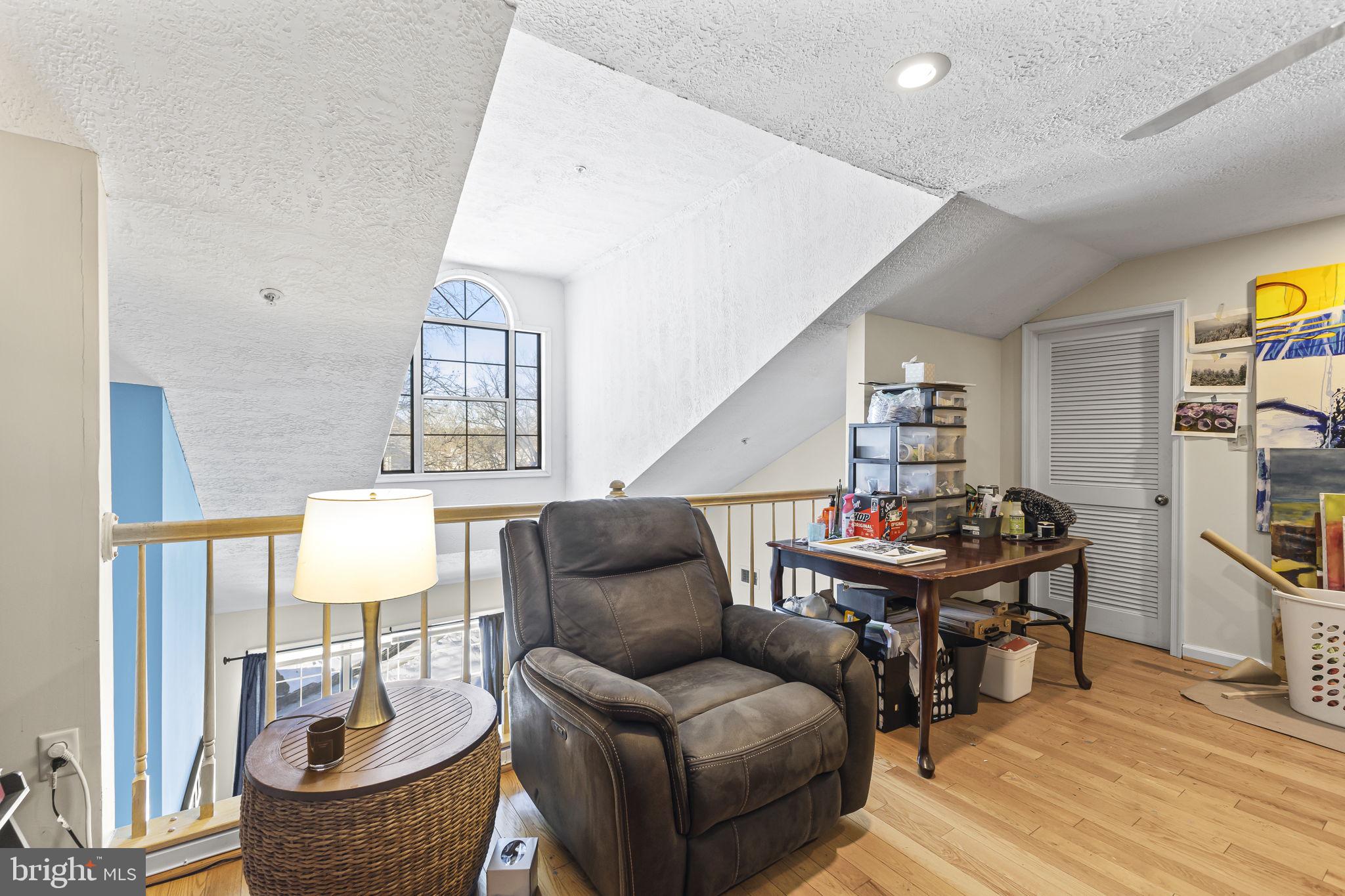 2320 Falls Gable Lane, Unit B Baltimore, MD 21209 - Photo 22 of 26 a living room with furniture and a wooden floor
