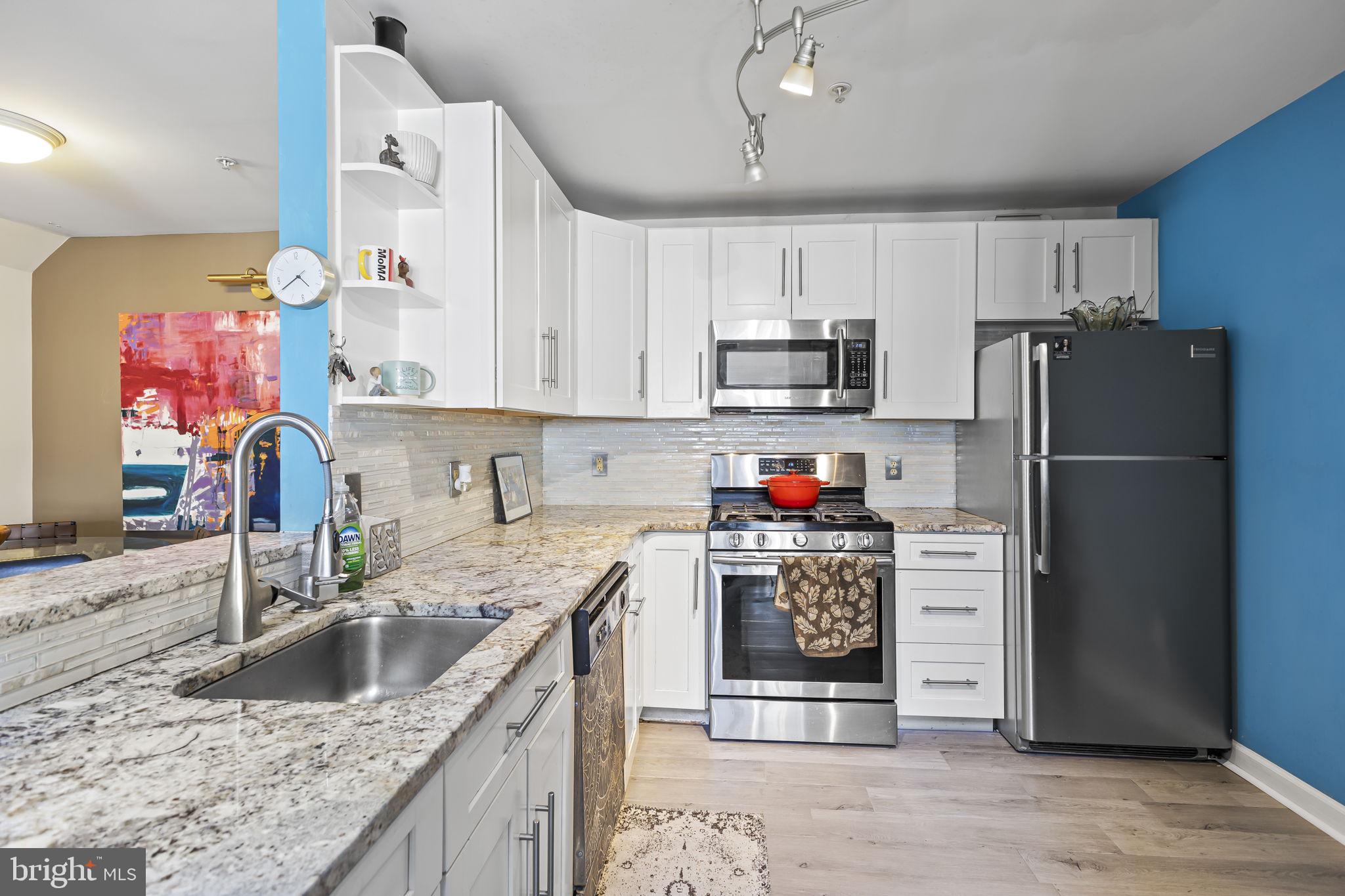 2320 Falls Gable Lane, Unit B Baltimore, MD 21209 - Photo 10 of 26 a kitchen with granite countertop a refrigerator stove and sink