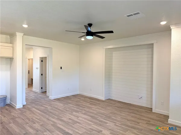 wooden floor in an empty room with a window
