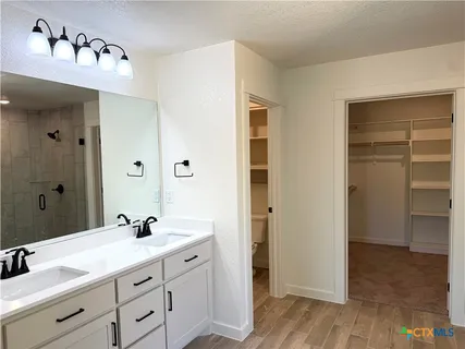 a bathroom with a double vanity sink and mirror