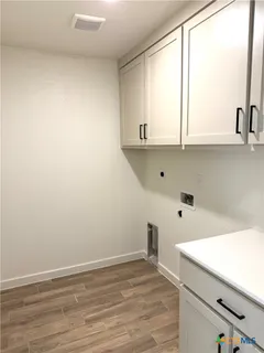 a view of kitchen with wooden floor and electronic appliances