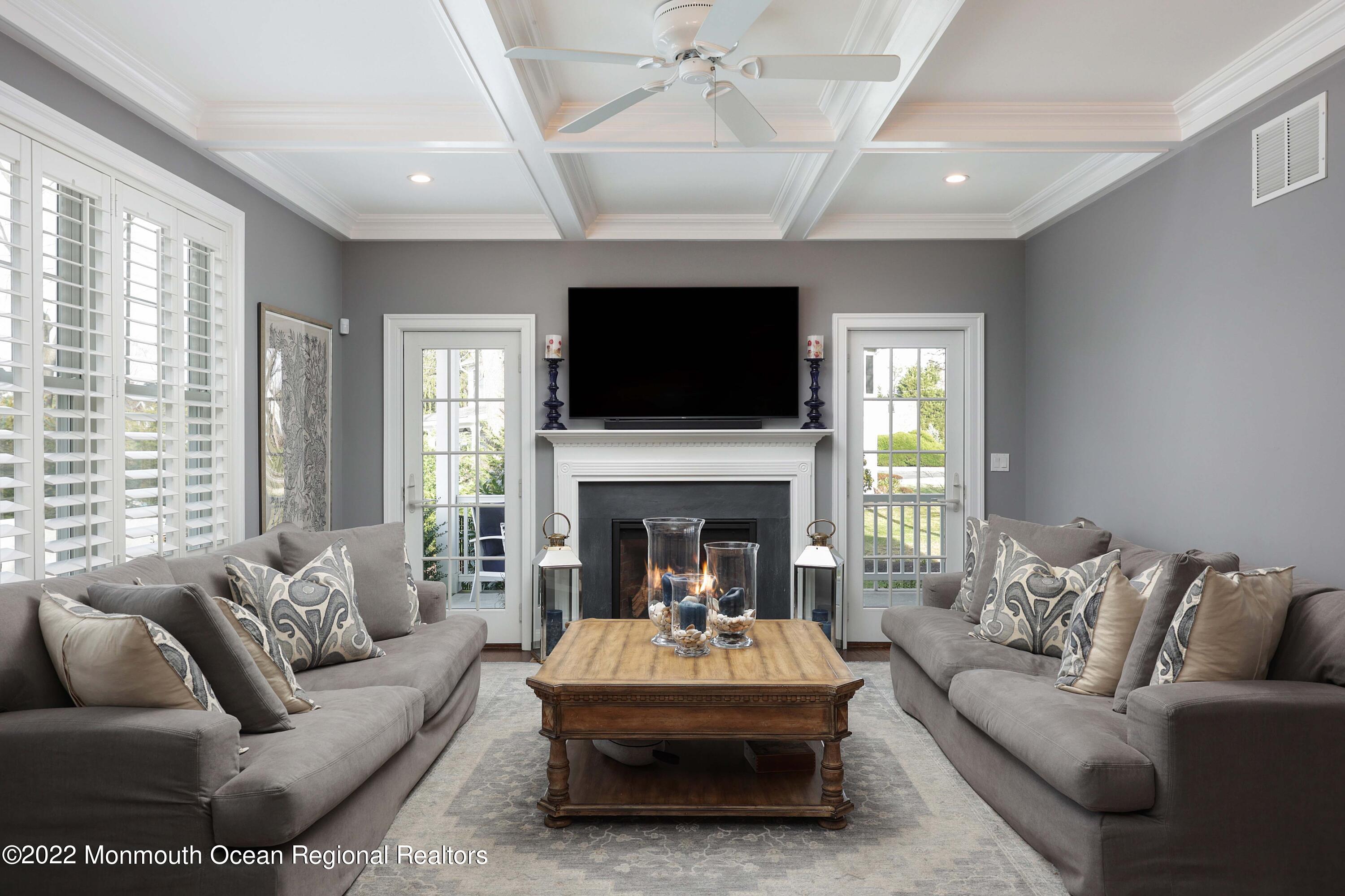 47 Shadowbrook Road Shrewsbury, NJ 07702 - Photo 12 of 39 a living room with furniture a fireplace and a flat screen tv