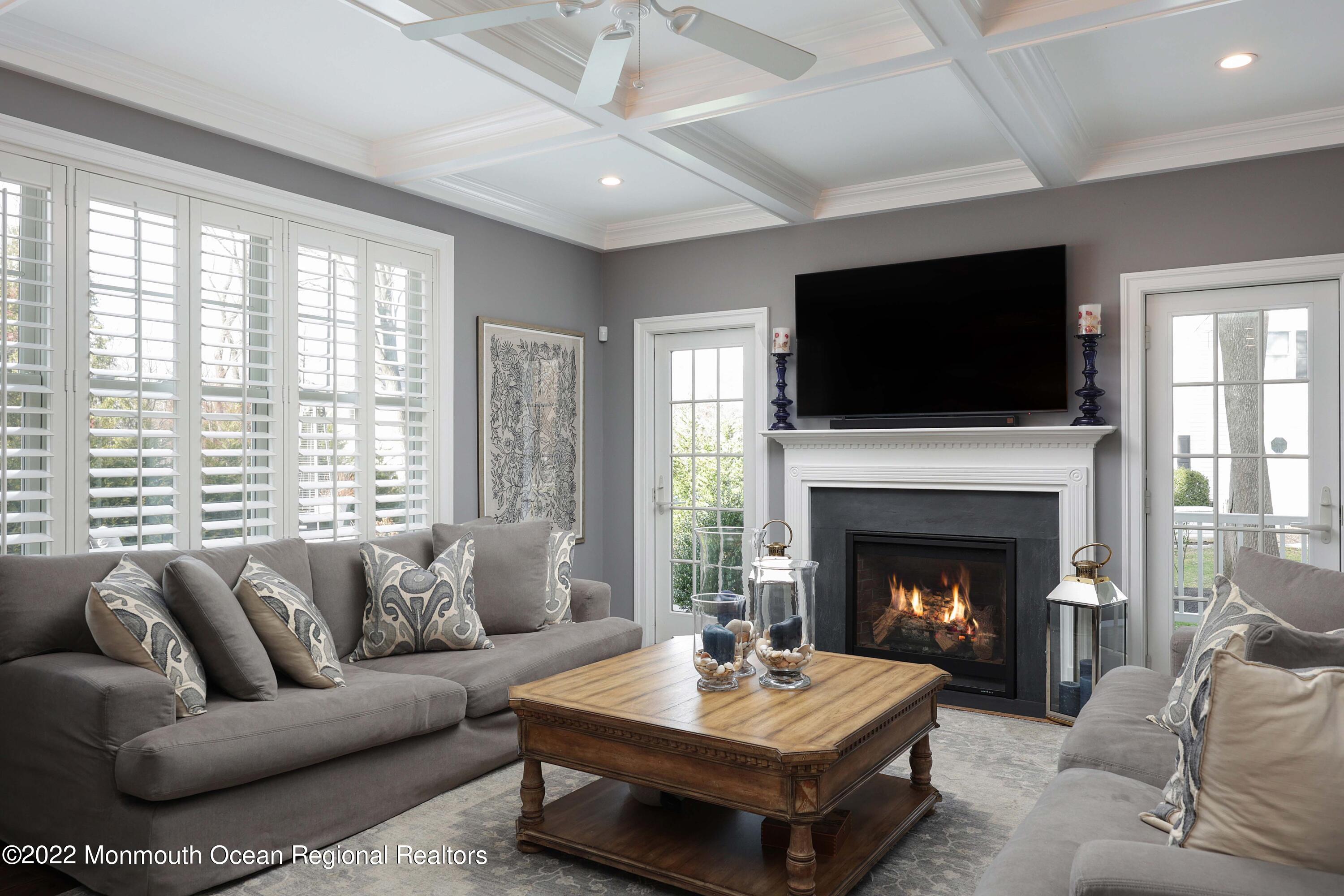 47 Shadowbrook Road Shrewsbury, NJ 07702 - Photo 13 of 39 a living room with furniture a flat screen tv and a fireplace