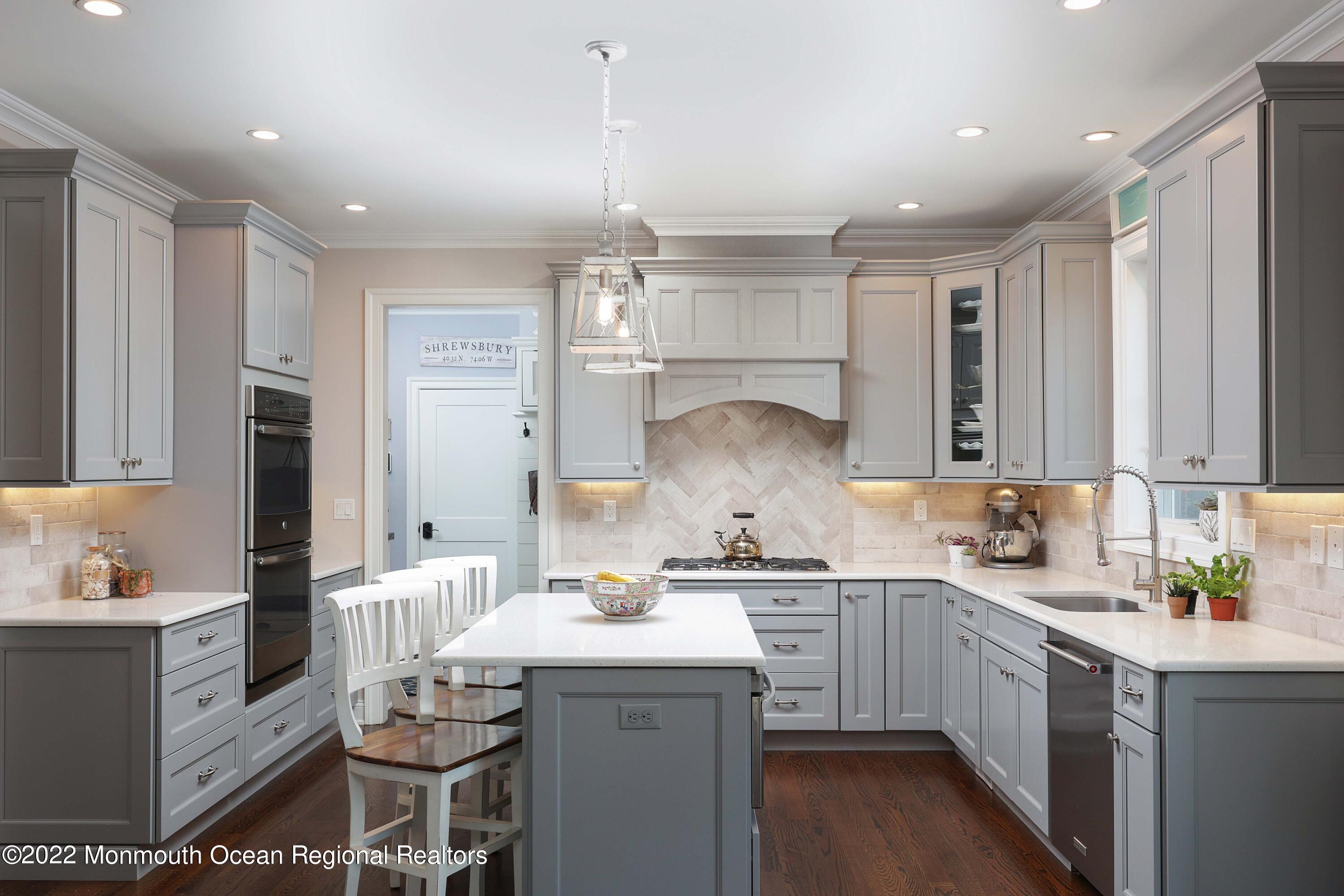 47 Shadowbrook Road Shrewsbury, NJ 07702 - Photo 14 of 39 a kitchen with a sink a stove a refrigerator and cabinets
