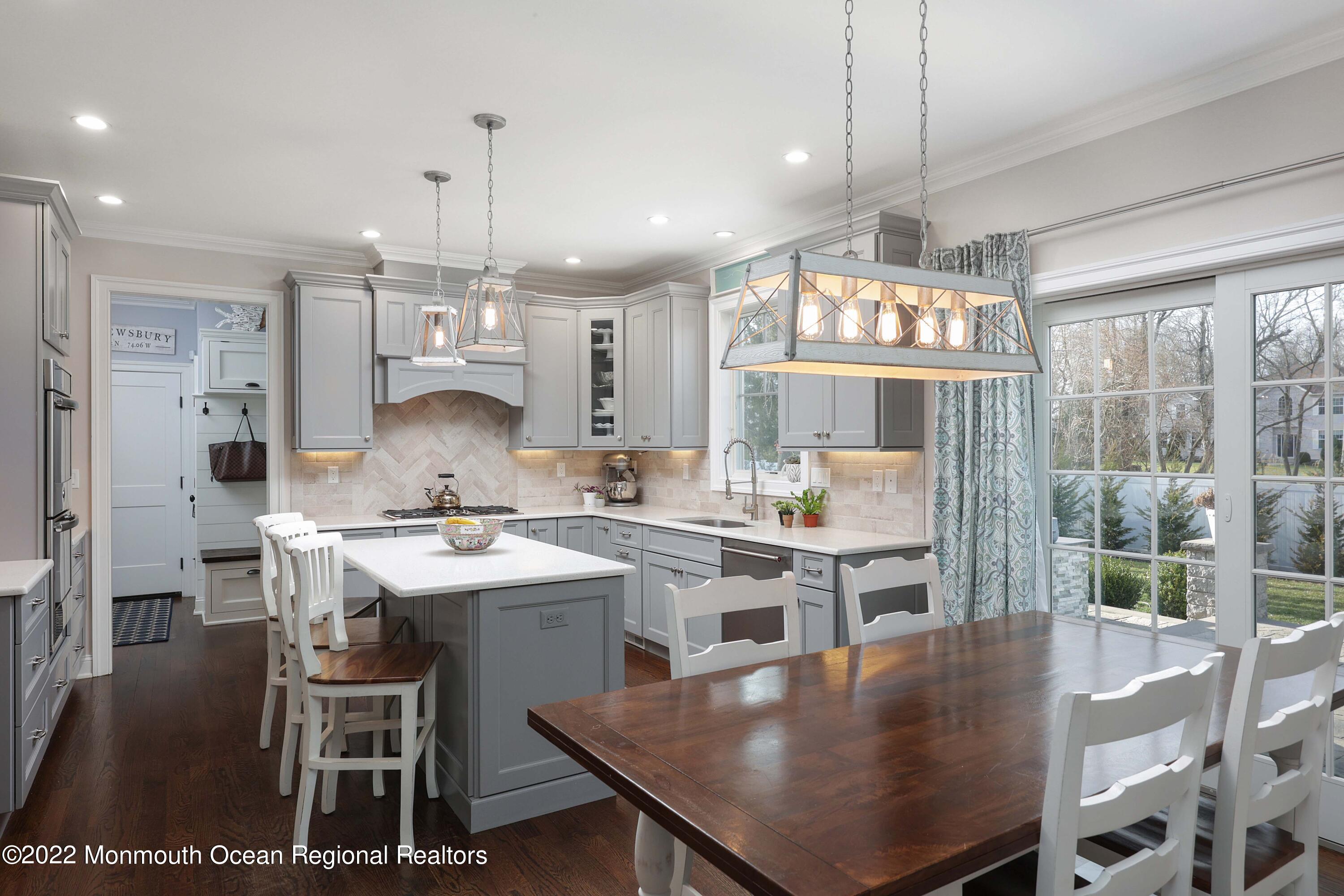 47 Shadowbrook Road Shrewsbury, NJ 07702 - Photo 16 of 39 a kitchen with kitchen island a table and chairs in it