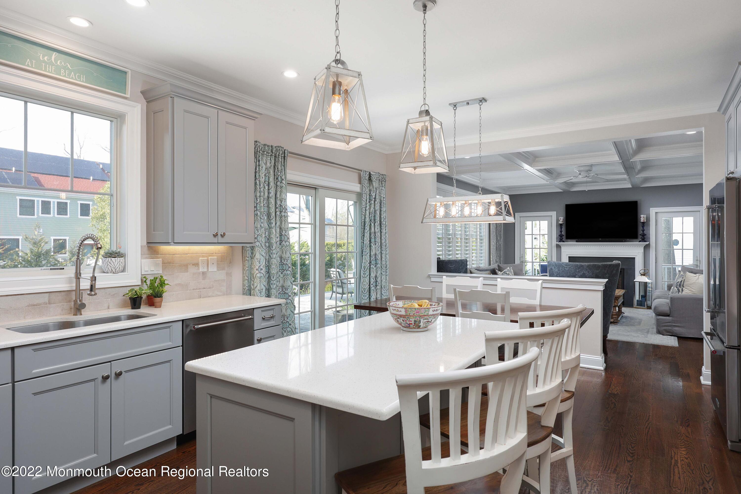 47 Shadowbrook Road Shrewsbury, NJ 07702 - Photo 17 of 39 a kitchen with kitchen island a sink and a stove top oven with wooden floor