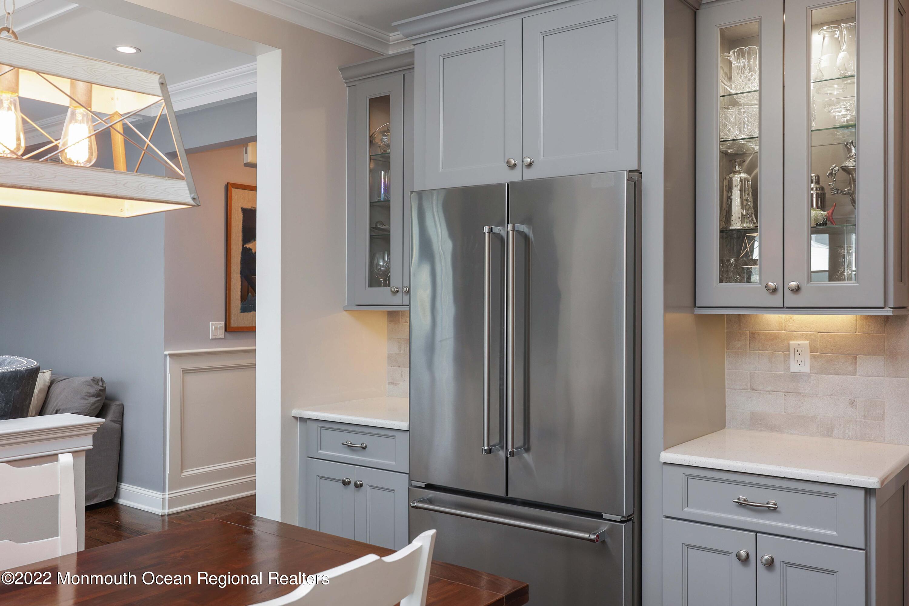 47 Shadowbrook Road Shrewsbury, NJ 07702 - Photo 19 of 39 a kitchen with white cabinets and refrigerator