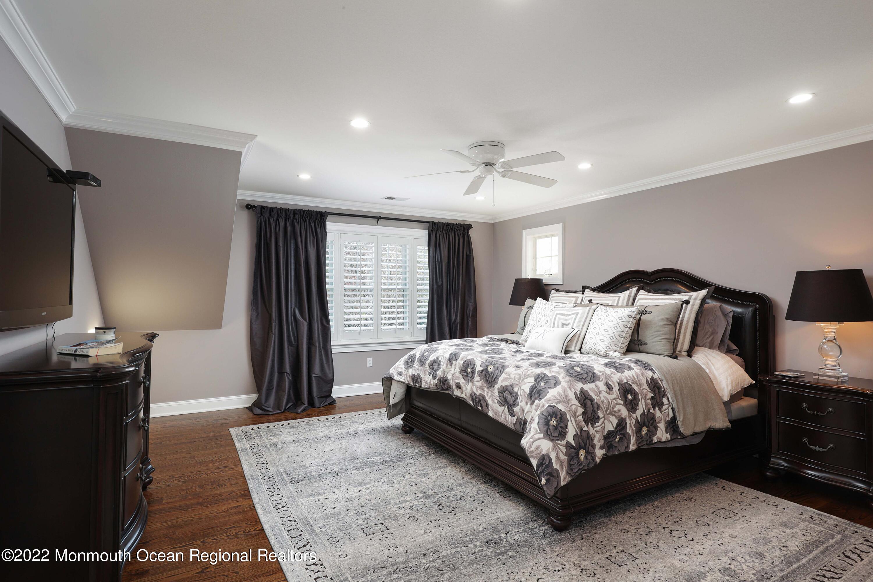 47 Shadowbrook Road Shrewsbury, NJ 07702 - Photo 20 of 39 a bedroom with a bed and a flat screen tv