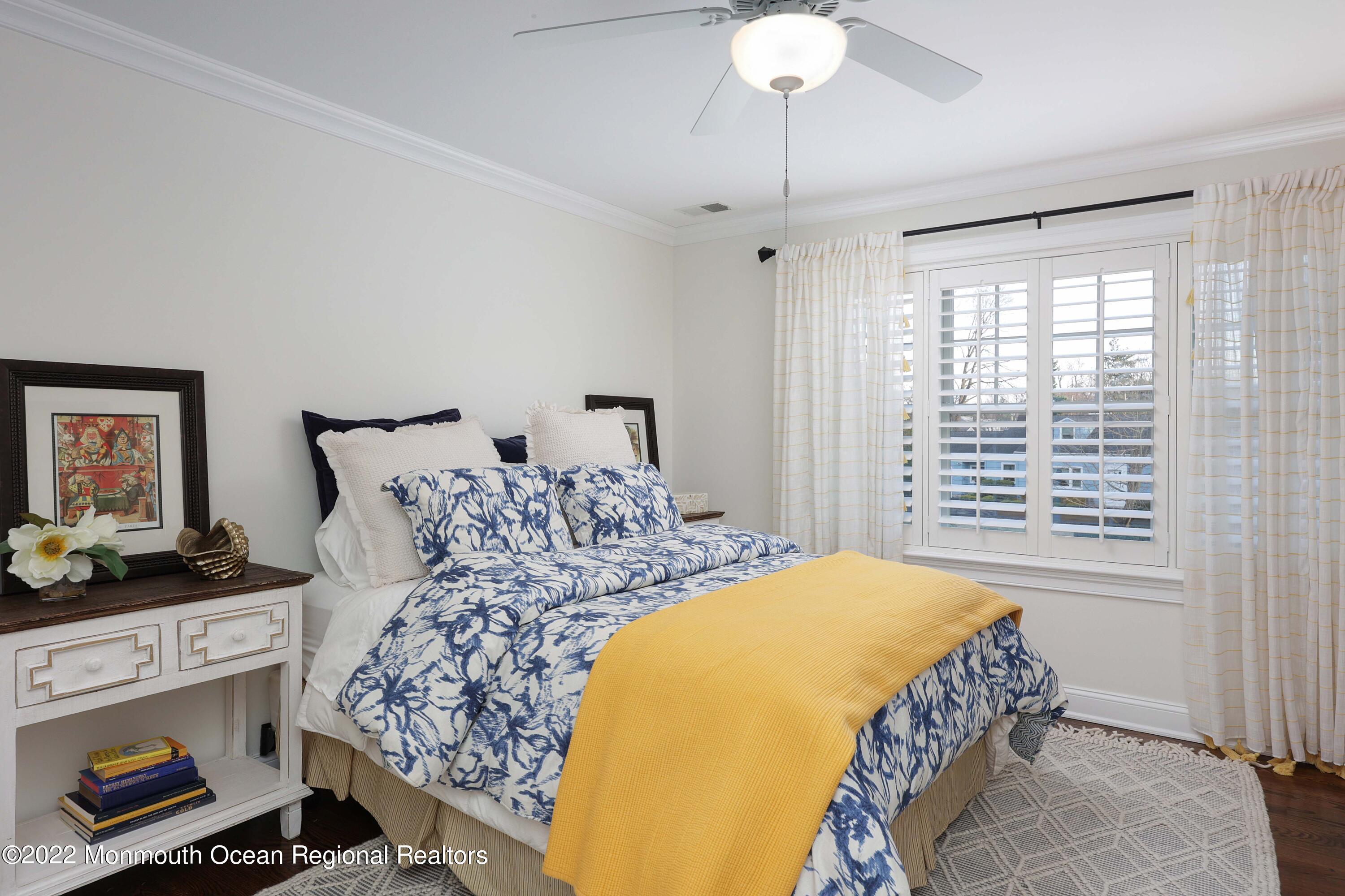 47 Shadowbrook Road Shrewsbury, NJ 07702 - Photo 25 of 39 a bedroom with a bed and a chandelier