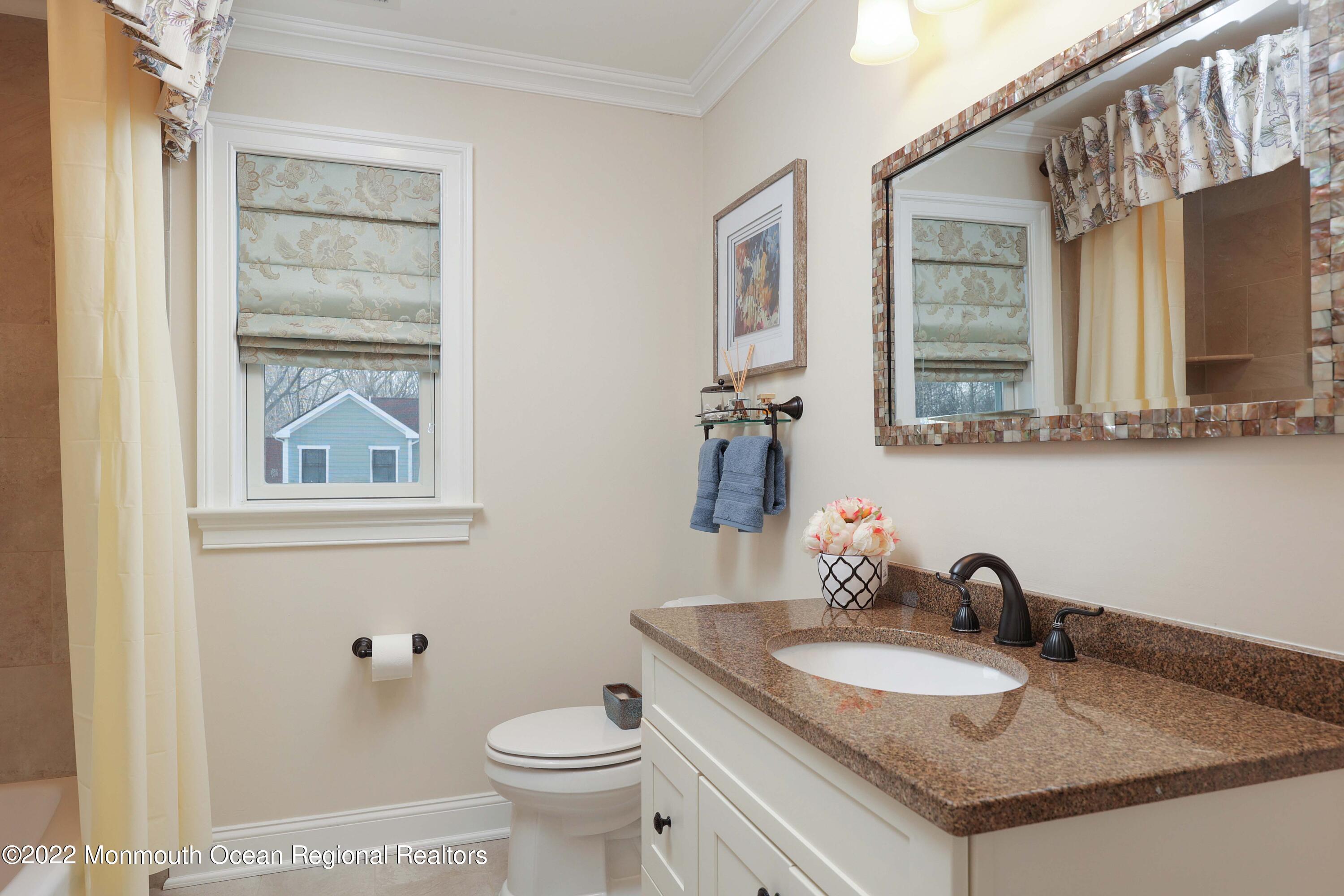 47 Shadowbrook Road Shrewsbury, NJ 07702 - Photo 26 of 39 a bathroom with a granite countertop sink and a mirror