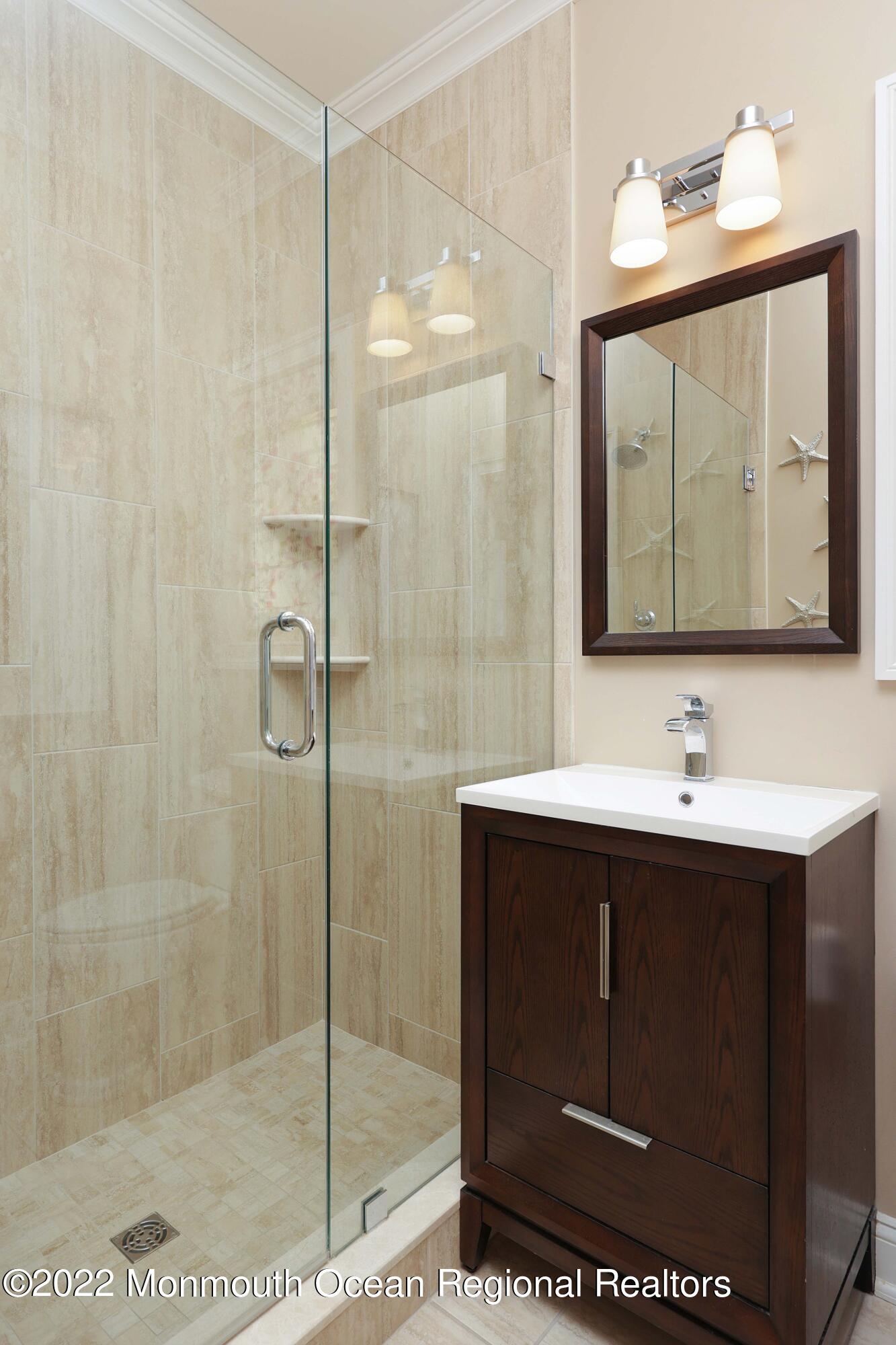 47 Shadowbrook Road Shrewsbury, NJ 07702 - Photo 28 of 39 a bathroom with a sink a mirror and shower