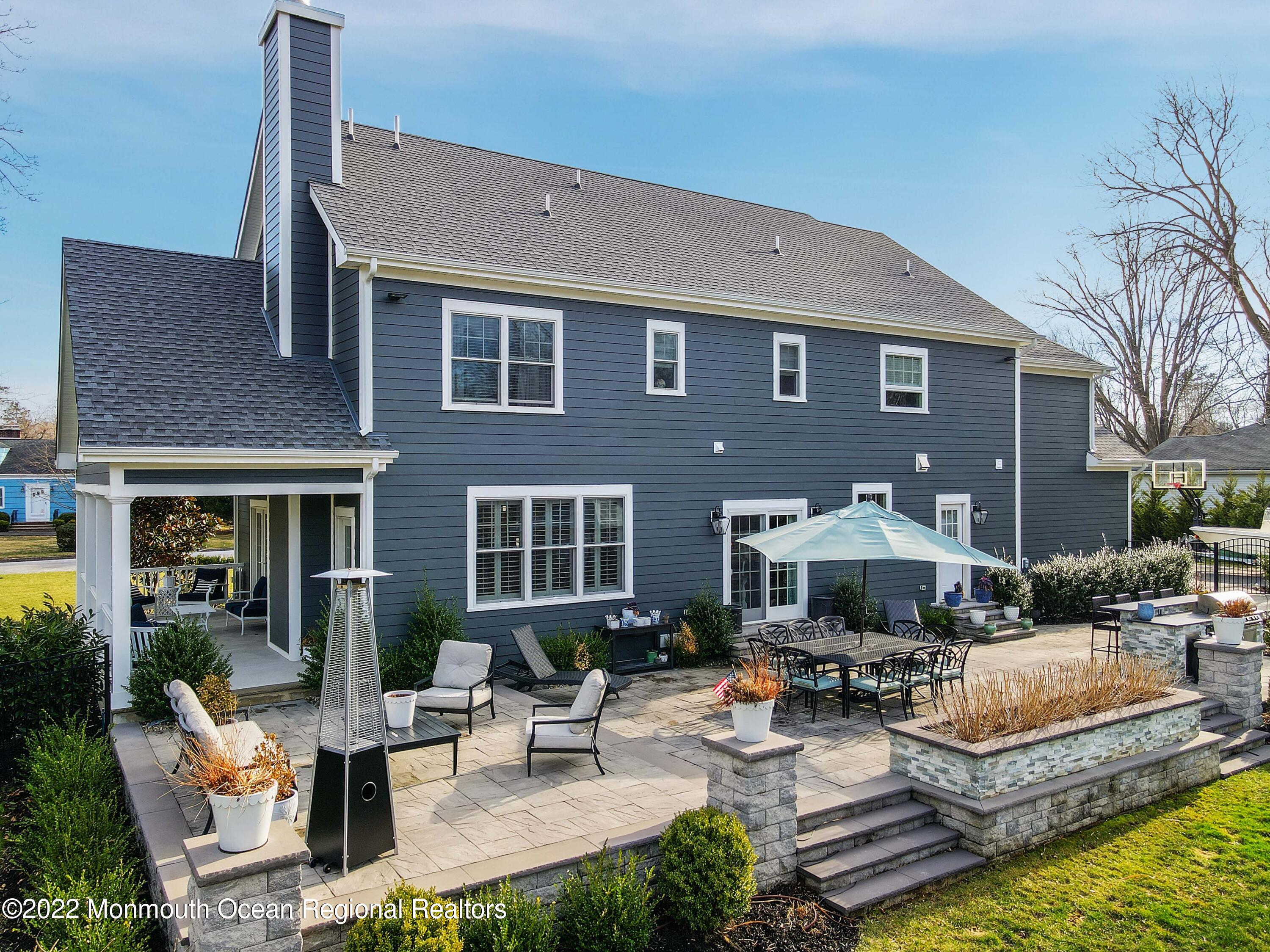 47 Shadowbrook Road Shrewsbury, NJ 07702 - Photo 34 of 39 a front view of a house with swimming pool and sitting area