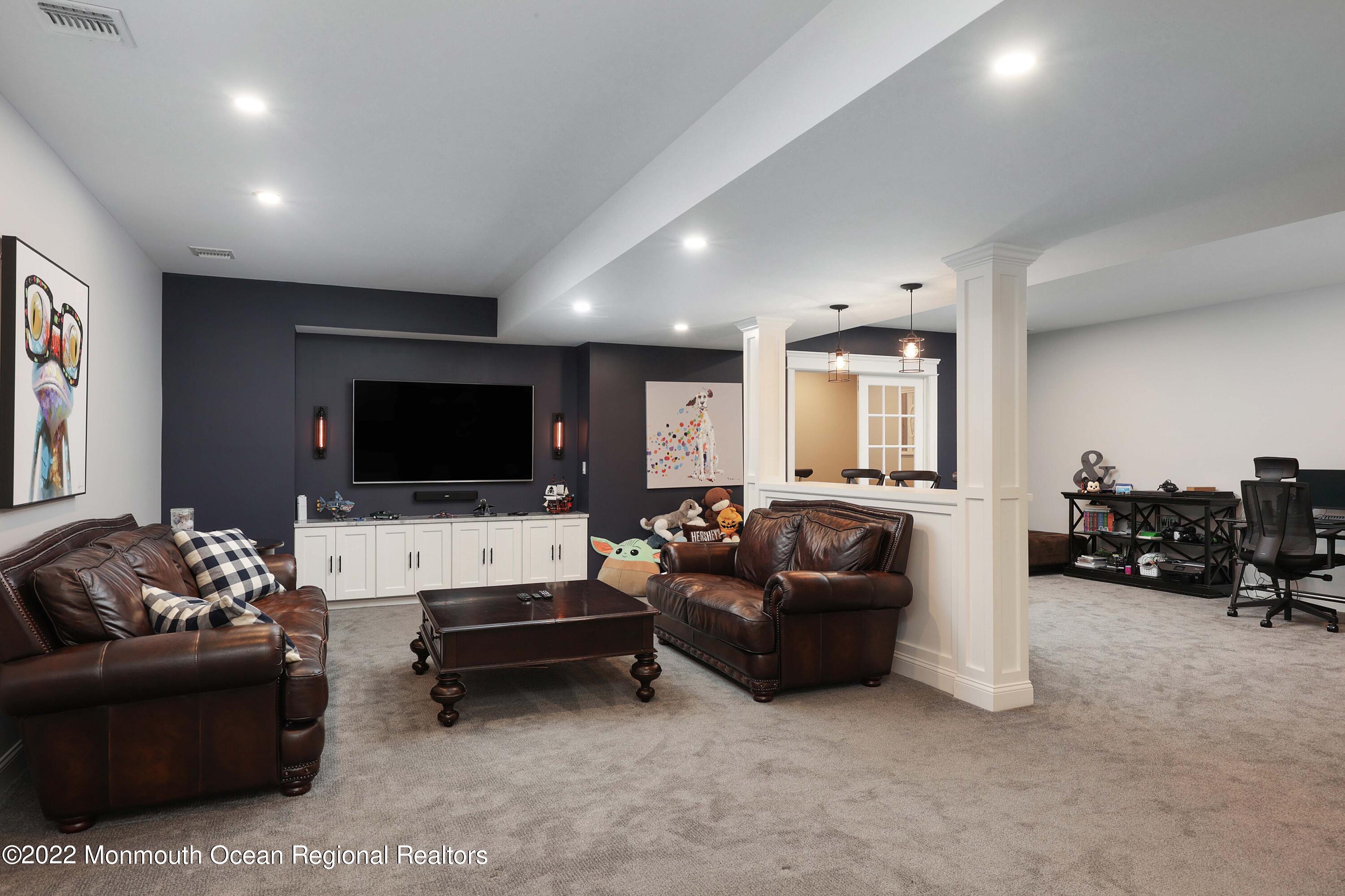 47 Shadowbrook Road Shrewsbury, NJ 07702 - Photo 37 of 39 a living room with furniture and a flat screen tv