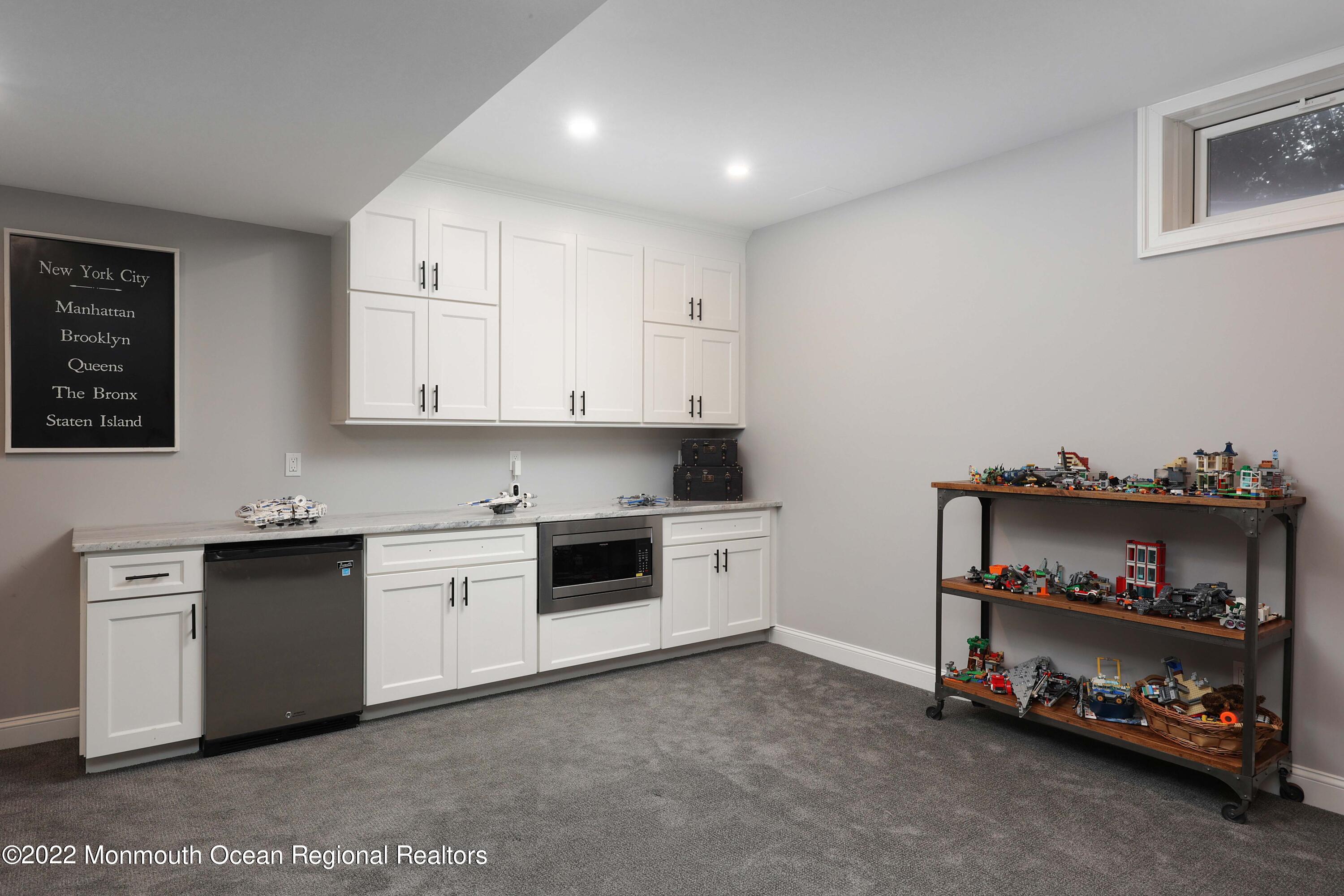 47 Shadowbrook Road Shrewsbury, NJ 07702 - Photo 38 of 39 a kitchen with stainless steel appliances granite countertop a stove and a refrigerator