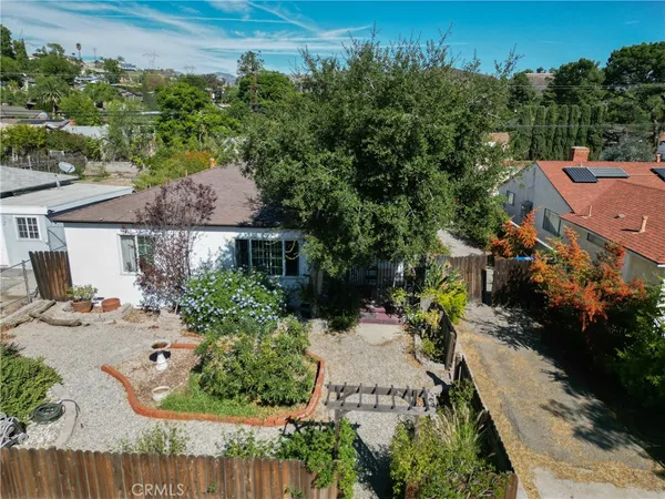 an aerial view of a house with garden space and street view