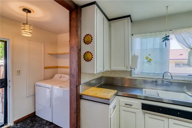 a kitchen with a sink and a refrigerator