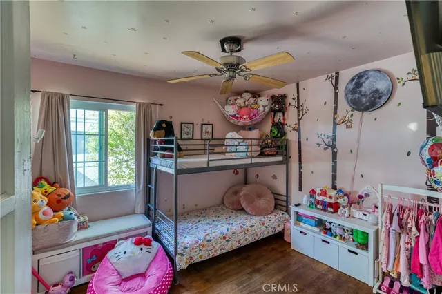 a bedroom with lots of furniture and wooden floor