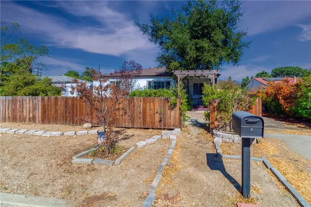 a backyard of a house with lots of green space and outdoor seating