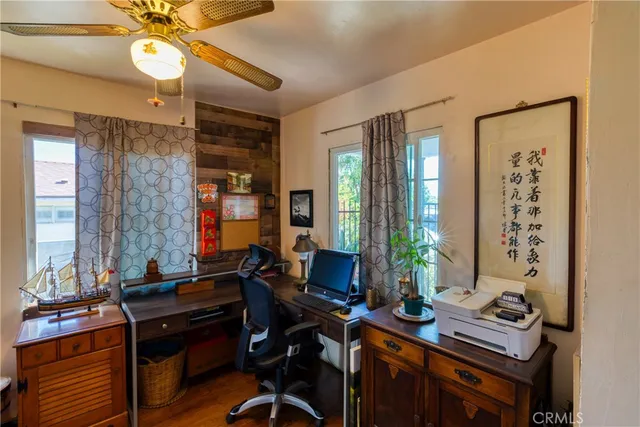 a view of a workspace with furniture and a window