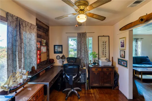 a view of a workspace with furniture and a window